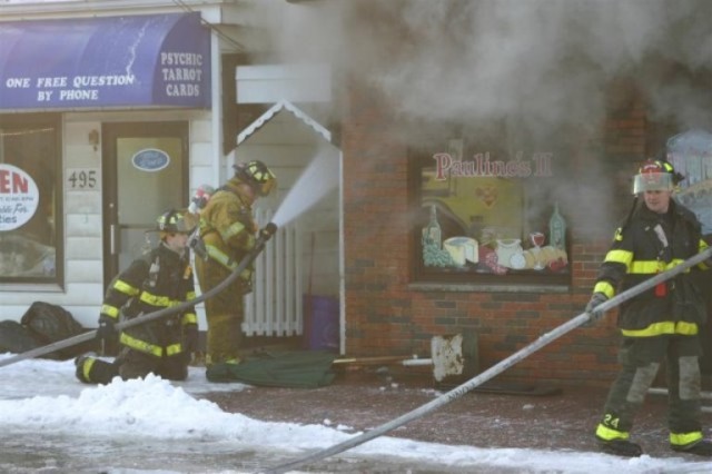 FF/EMT Bennett and FF Silveira operate a hoseline at the strip mall fire on New Brunswick Avenue.